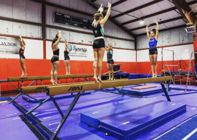 Young girl gymnasts on balance beams