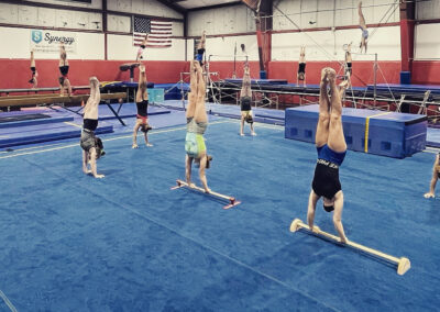 Young gymnasts practicing handstands