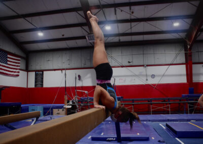 Young girl gymnast on balance beam