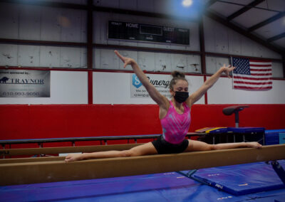 Young girl gymnast on balance beam