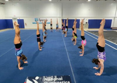 young girl gymnasts performing handstands